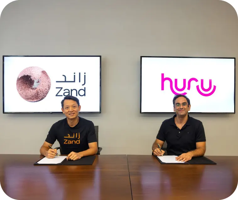 Zand and Huru executives signing their partnership agreement